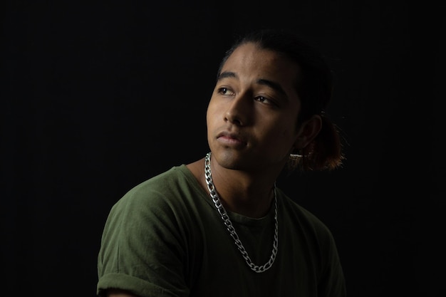 Young latin model in a studio photo shoot with a black background