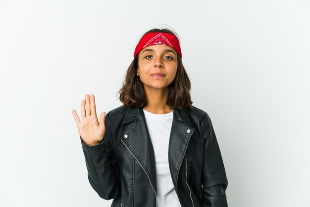 Young latin rocker woman isolated on white wall laughing about something, covering mouth with hands.