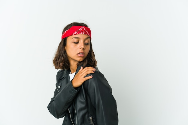 Young latin rocker woman isolated on white wall massaging elbow, suffering after a bad movement.