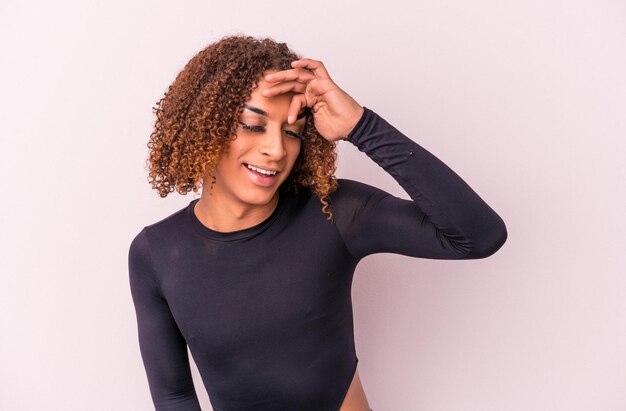 Young latin transsexual woman isolated on pink background joyful laughing a lot. Happiness concept.