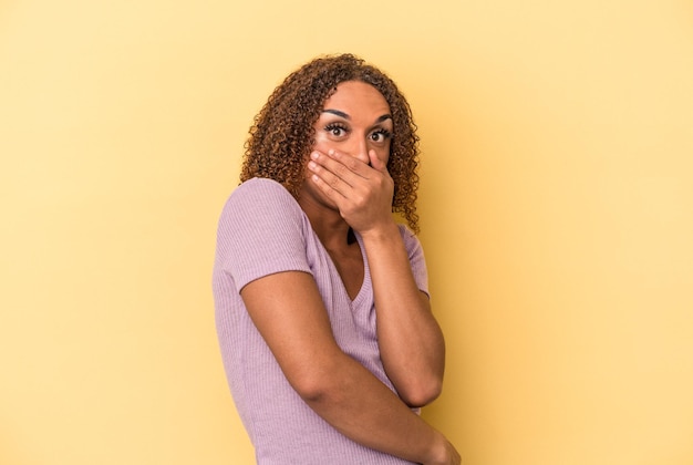 Young latin transsexual woman isolated on yellow background scared and afraid.