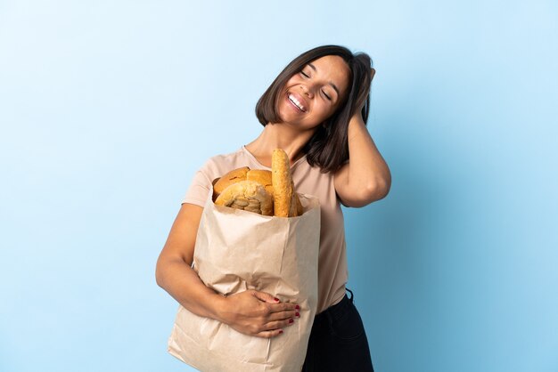 Young latin woman buying some bread