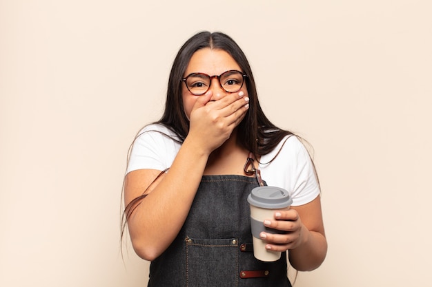 Young latin woman covering mouth with hands with a shocked, surprised expression, keeping a secret or saying oops