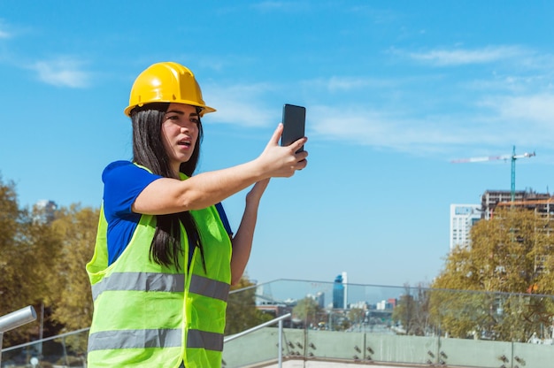 Young latin woman engineer outdoors outraged by the message they sent her on the phone