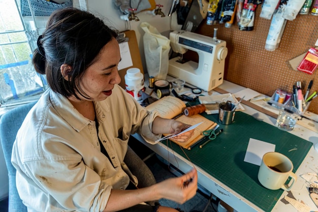 Young latin woman in her own painting studio creates paintings different artistic techniques