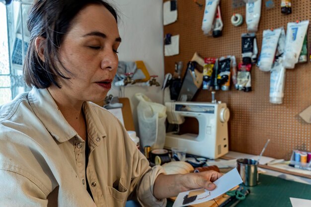 Young latin woman in her own painting studio creates paintings different artistic techniques