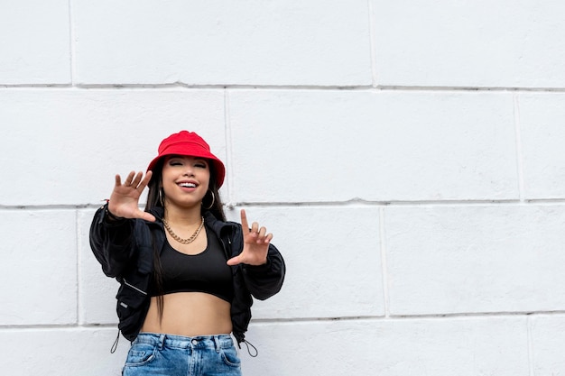 Young latin woman hip hop dancing in the street with a red hat panama central america stock photo