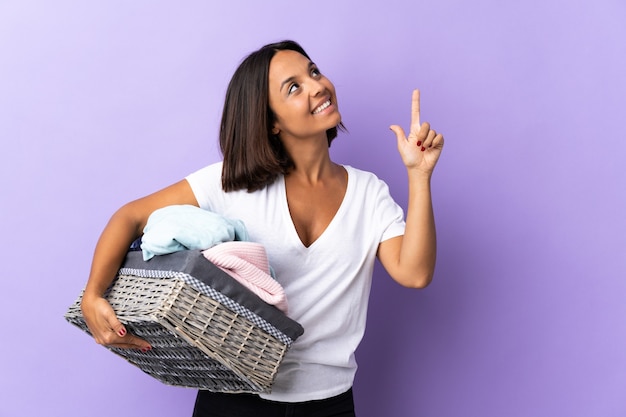 Young latin woman holding a clothes basket