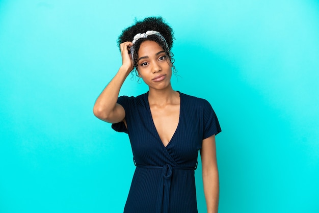 Young latin woman isolated on blue background with an expression of frustration and not understanding