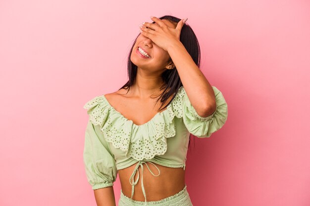 Young latin woman isolated on pink background  covers eyes with hands, smiles broadly waiting for a surprise.