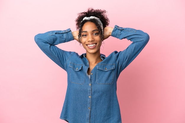 Young latin woman isolated on pink background laughing