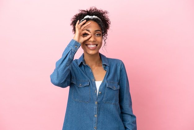 Young latin woman isolated on pink background showing ok sign with fingers