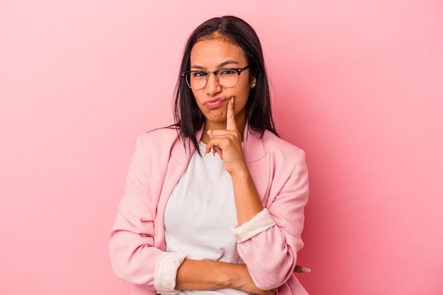 Young latin woman isolated on pink background  unhappy looking in camera with sarcastic expression