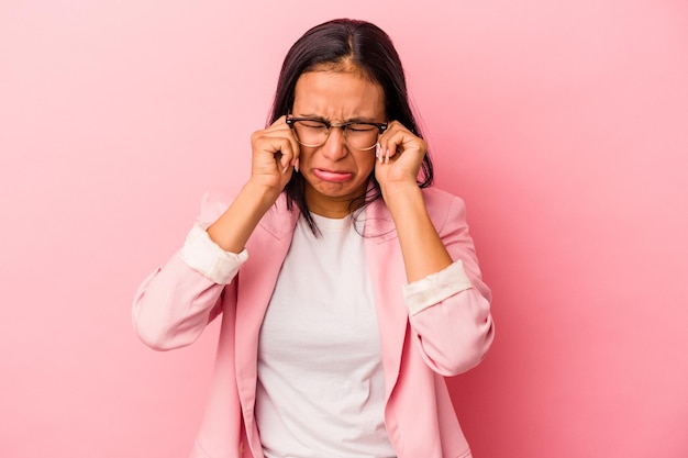 Young latin woman isolated on pink background  whining and crying disconsolately