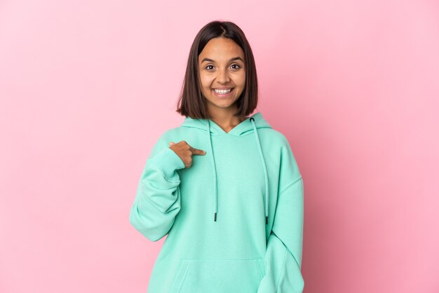 Young latin woman isolated on pink background with surprise facial expression