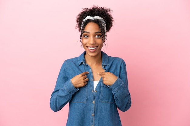 Young latin woman isolated on pink background with surprise facial expression