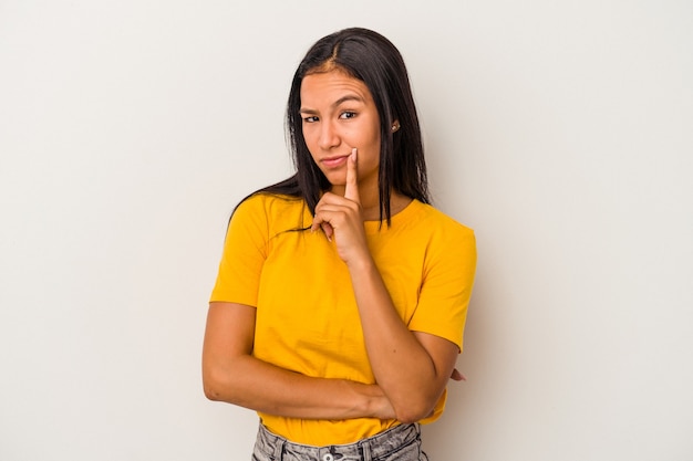 Young latin woman isolated on white background  contemplating, planning a strategy, thinking about the way of a business.