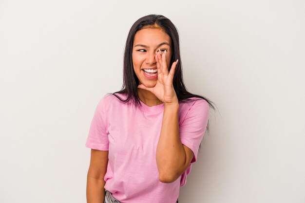 Young latin woman isolated on white background  shouting excited to front