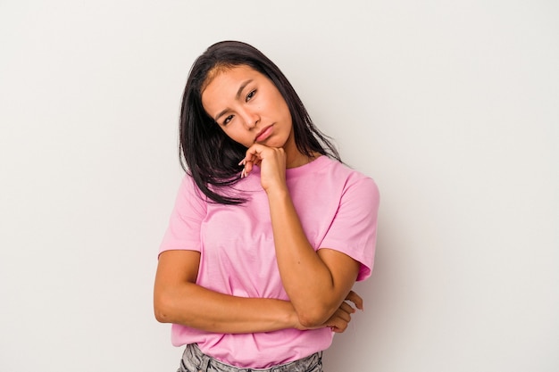 Young latin woman isolated on white background  tired of a repetitive task.