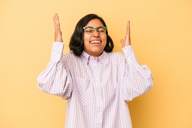 Young latin woman isolated on yellow background joyful laughing a lot. Happiness concept.