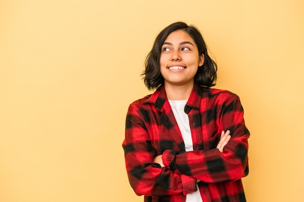 Photo young latin woman isolated on yellow background smiling confident with crossed arms.