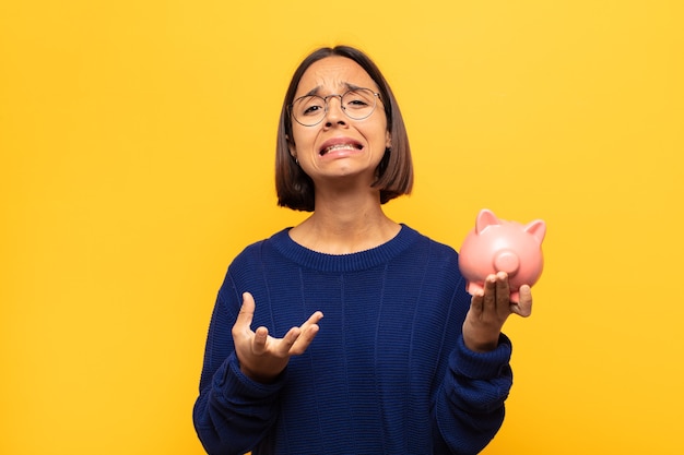 Young latin woman looking desperate and frustrated