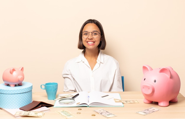 Photo young latin woman looking happy and goofy with a broad