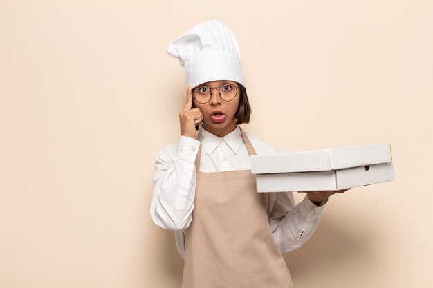 Young latin woman looking surprised, open-mouthed, shocked, realizing a new thought, idea or concept