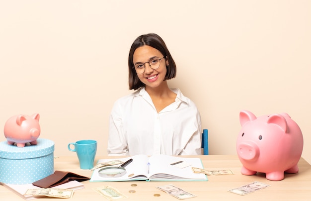 Young latin woman smiling cheerfully and casually with a positive, happy, confident and relaxed expression