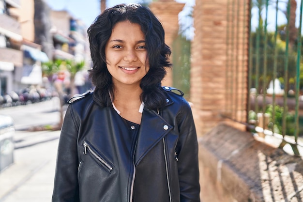 Young latin woman smiling confident standing at street