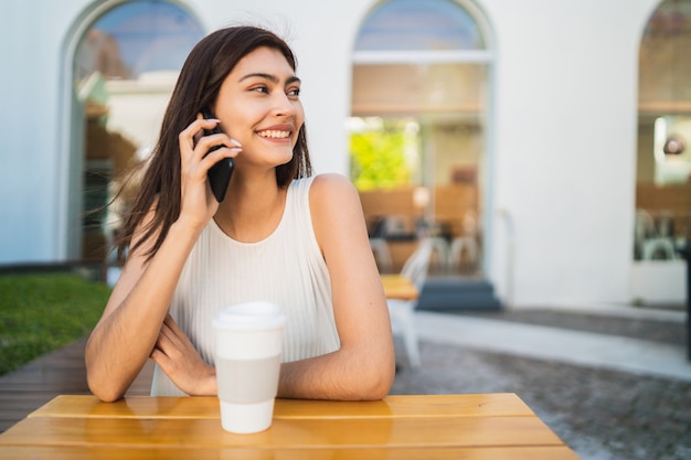 Young latin woman talking on the phone.