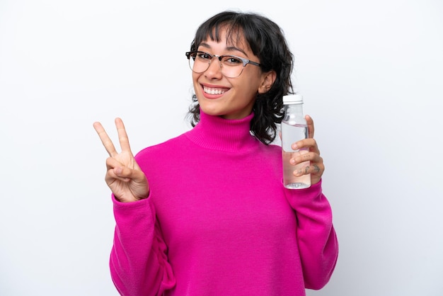 Young latin woman wearing a pink sweater and holding a water bottle