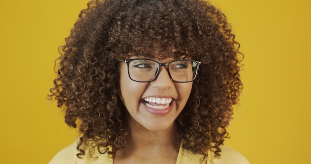 Photo young latin woman with curly hair happy with her glasses. eye care concept.