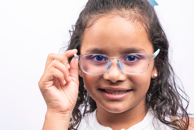 Young latin woman with smiling glasses pointing on white background