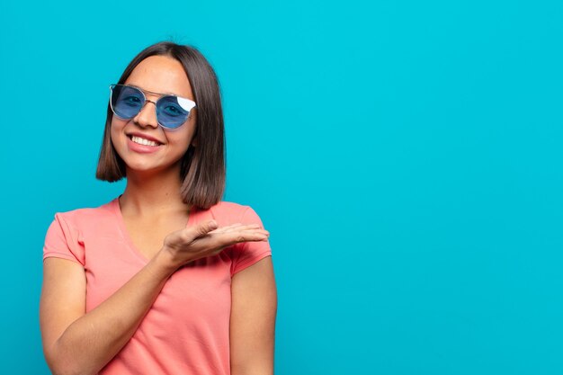 Young latin woman with sun glasses and a copy space