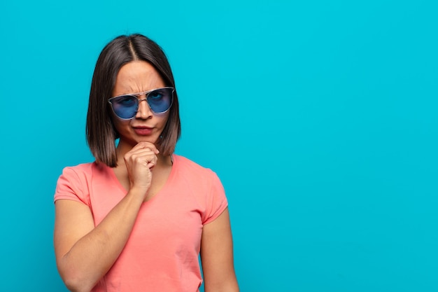 Young latin woman with sun glasses and a copy space