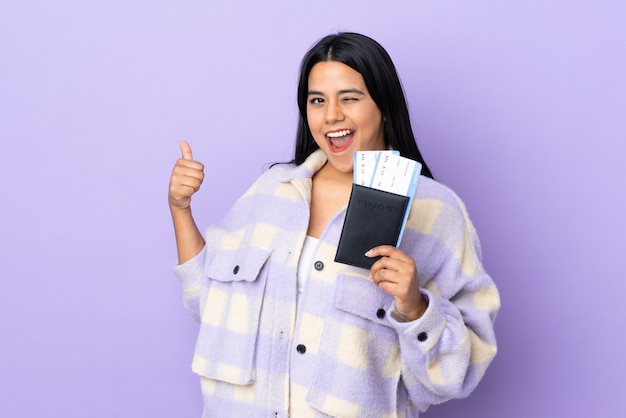 Young latin woman woman isolated on purple