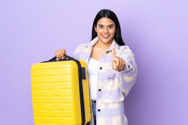 Young latin woman woman isolated on purple