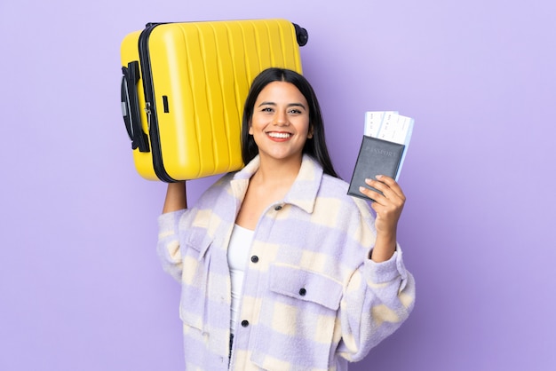 Young latin woman woman isolated on purple