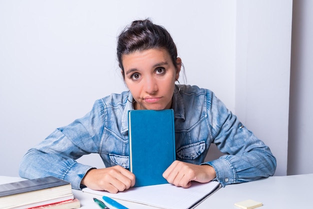 Young latina woman bored not wanting to study looking ahead university