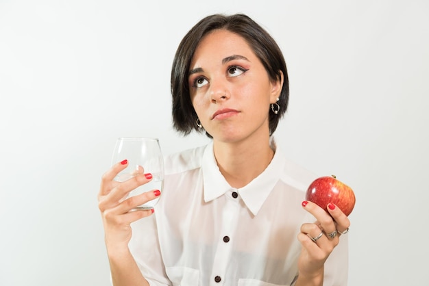 Young latina woman offering a glass of water diet healthy living