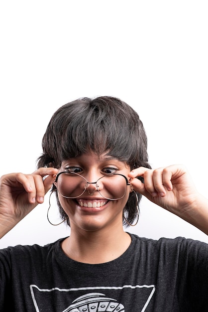 Young latina woman with glasses making funny gestures on white background