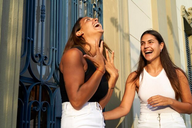 Young latina women have fun on the street