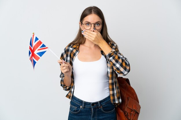 Young Lithuanian woman holding an United Kingdom flag isolated