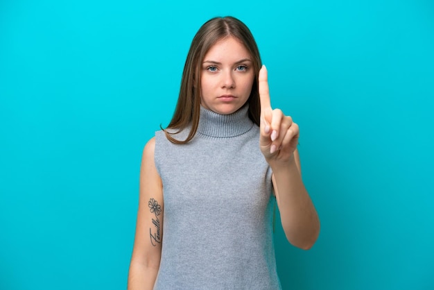 Young Lithuanian woman isolated on blue background counting one with serious expression