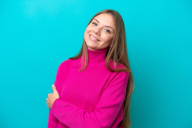 Young Lithuanian woman isolated on blue background laughing