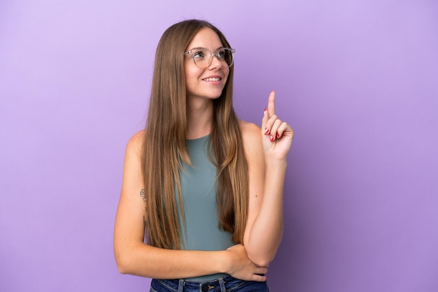 Young Lithuanian woman isolated on purple background pointing up a great idea