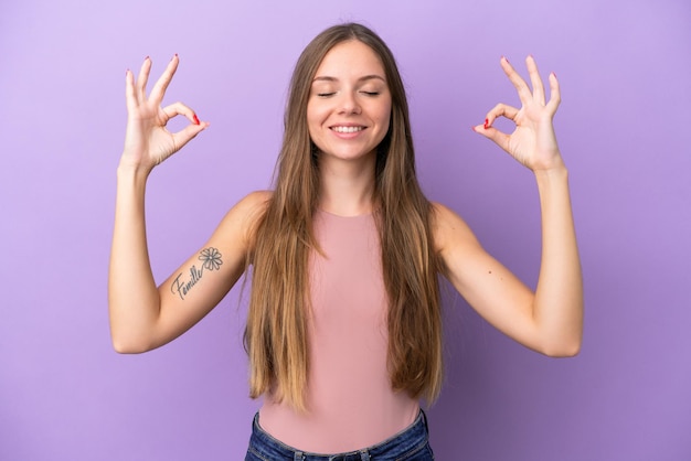 Young Lithuanian woman isolated on purple background in zen pose