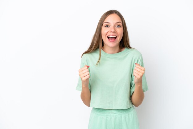 Young Lithuanian woman isolated on white background celebrating a victory in winner position