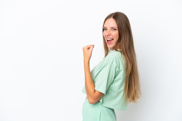 Young Lithuanian woman isolated on white background celebrating a victory